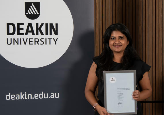 A staff member posing with their VC award
