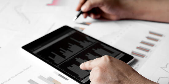 Deakin business analytics student looking at data on ipad.