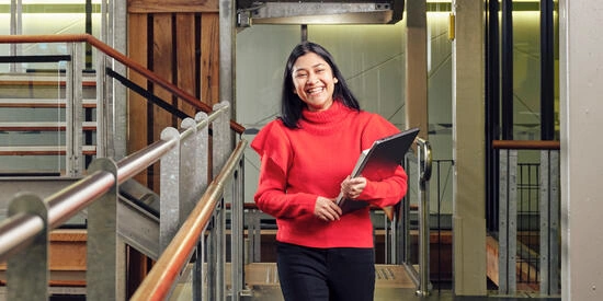 Deakin university engilsh language langguage institute student standing and smiling.