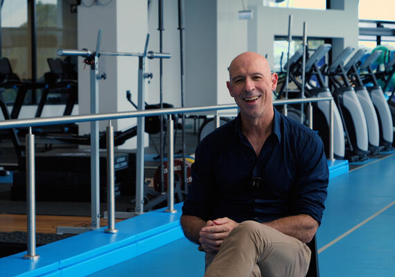 Person sitting in exercise science lab in front of camera