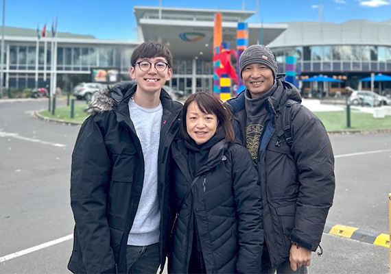 Sport management student Oscar Yam with his parents.