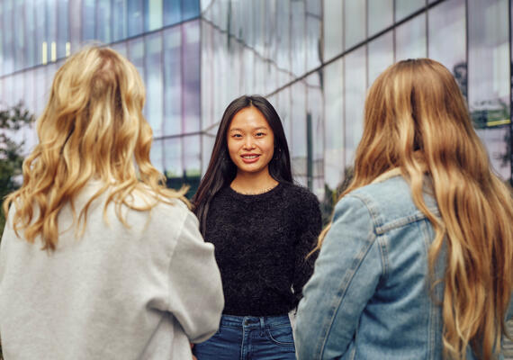 Deakin Engagement and Access Program participants stand in a circle with the middle student smiling.