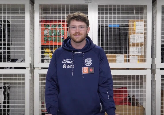 A Geelong Cats intern smiles at the camera