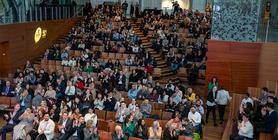 Crowd watching presentation in auditorium