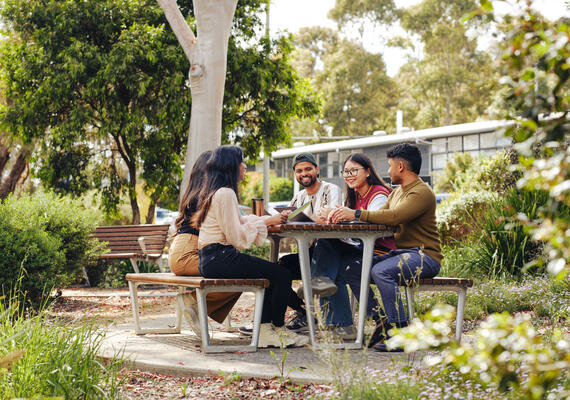 Two students studying outside on the Burwood campus.