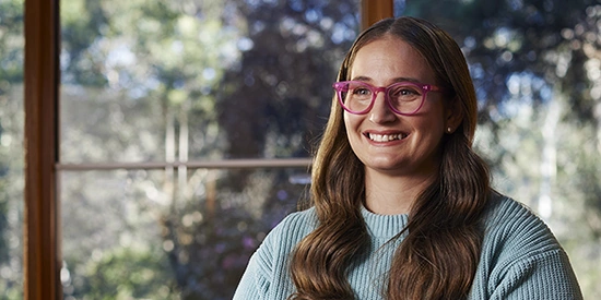 A Deakin online student sitting in front of a window
