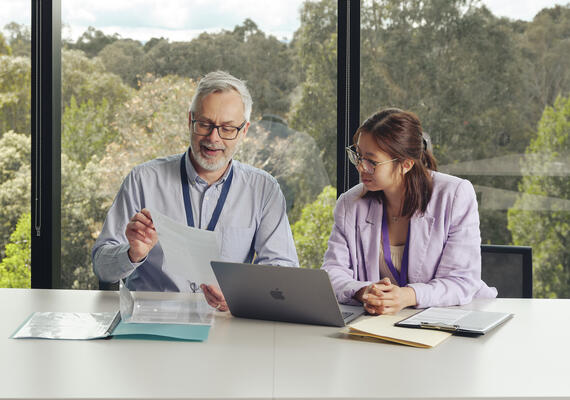 Two postgraduate health students sit talking at the Burwood campus