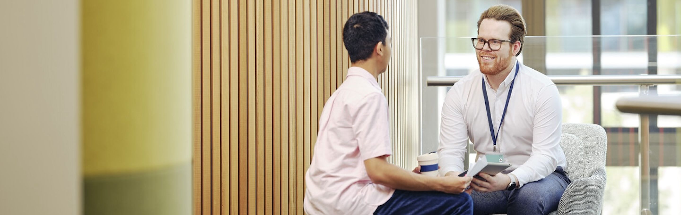 Two people sitting on chairs
