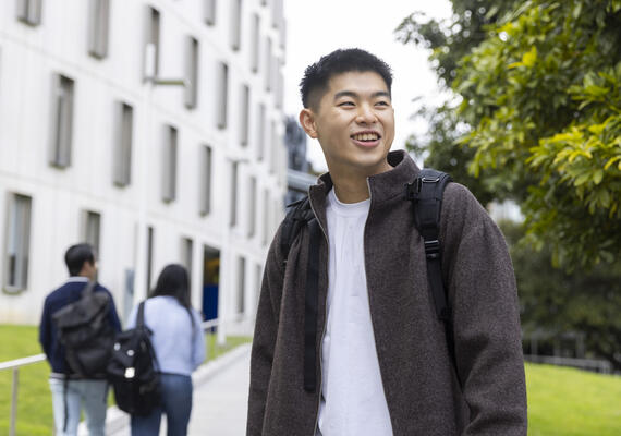 Deakin student stands outside at Burwood Campus.