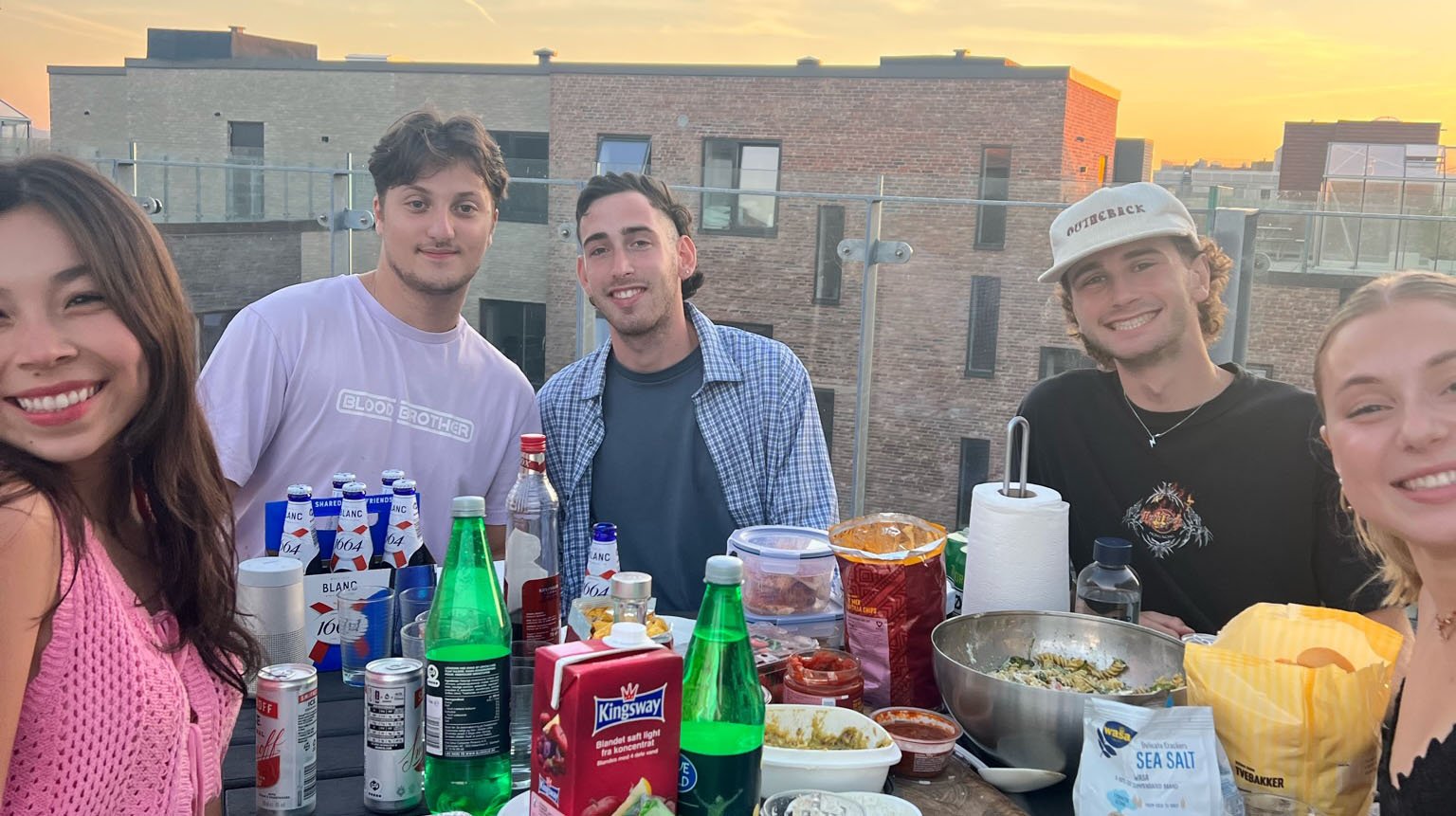 Friends sitting around a dinner table outside