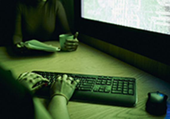 two students viewing computer at night