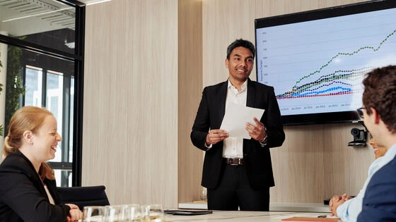 A Deakin MBA student smiles while making to a presentation.