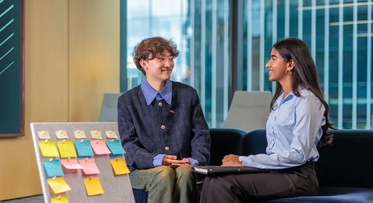 Two students prepare a presentation.