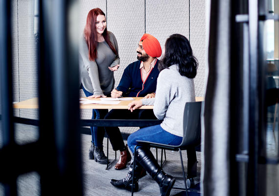 Staff members gathered around a desk