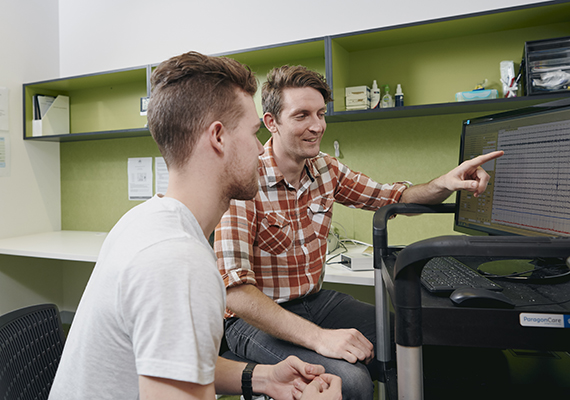 A career counsellor interacts with a student while looking at a desktop screen 