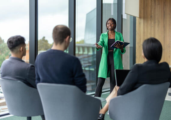 a small group of organisational development psychology students in a management meeting scenario