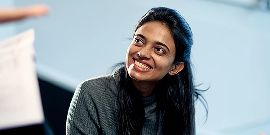 A close up of a student looking up and smiling.