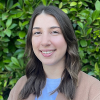 A headshot of Nicollette Raftopoulos smiling at the camera.