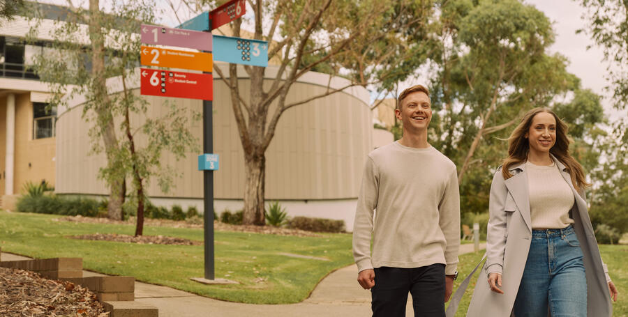 Two Deakin students walk through the Geelong Waurn Ponds campus