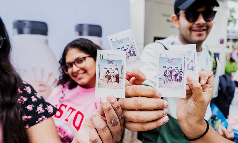 Group of students with polaroid photos