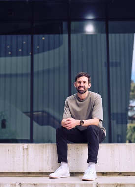 Deakin law student sitting on step