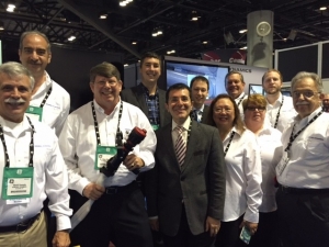 Dr James Mullins, Professor Saeid Nahavandi (front centre) and Dr Kyle Nelson, with General Dynamics staff at the I/ITSEC stand. 