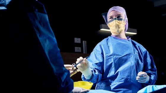 Two Deakin master of advanced clinical nursing students in an operating theatre during surgery.