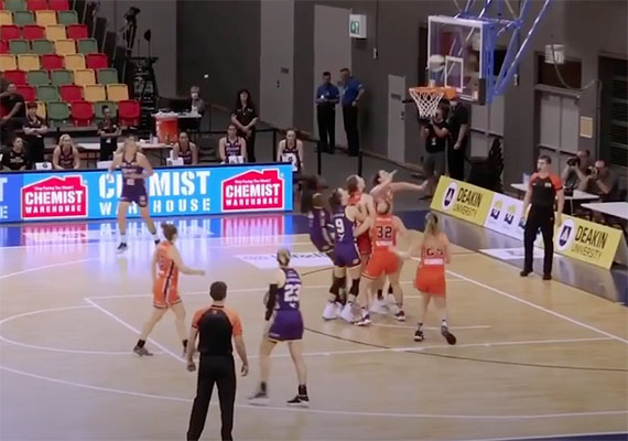 Players shooting at the hoop.