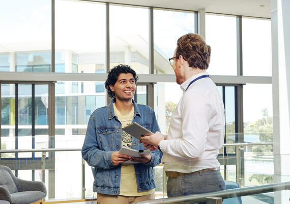 Staff interacting and assisting a student one-on-one on the Burwood campus