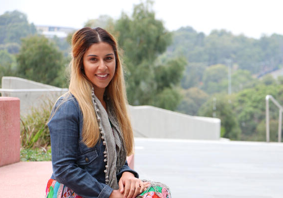 Student smiles at camera on campus