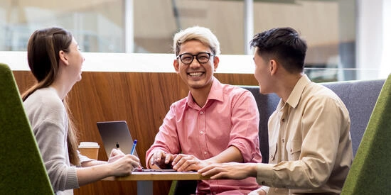 Students studying together in a booth on campus