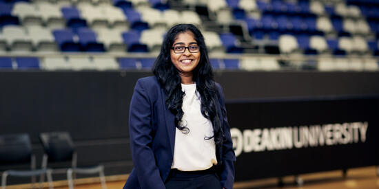 A student standing in an indoor court at Parkville Sports Centre.
