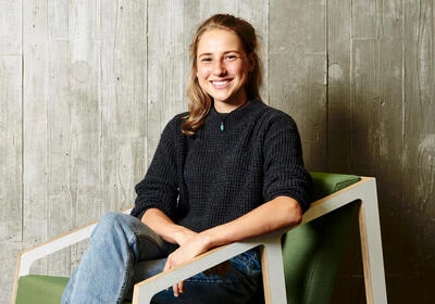 Alice Bleathman, Deakin student and scholarship recipient sitting on a chair.