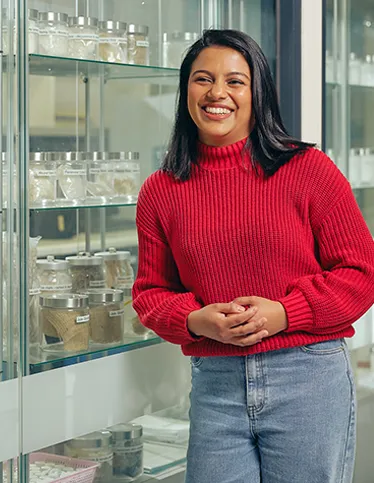 Deakin researcher smiling on campus.