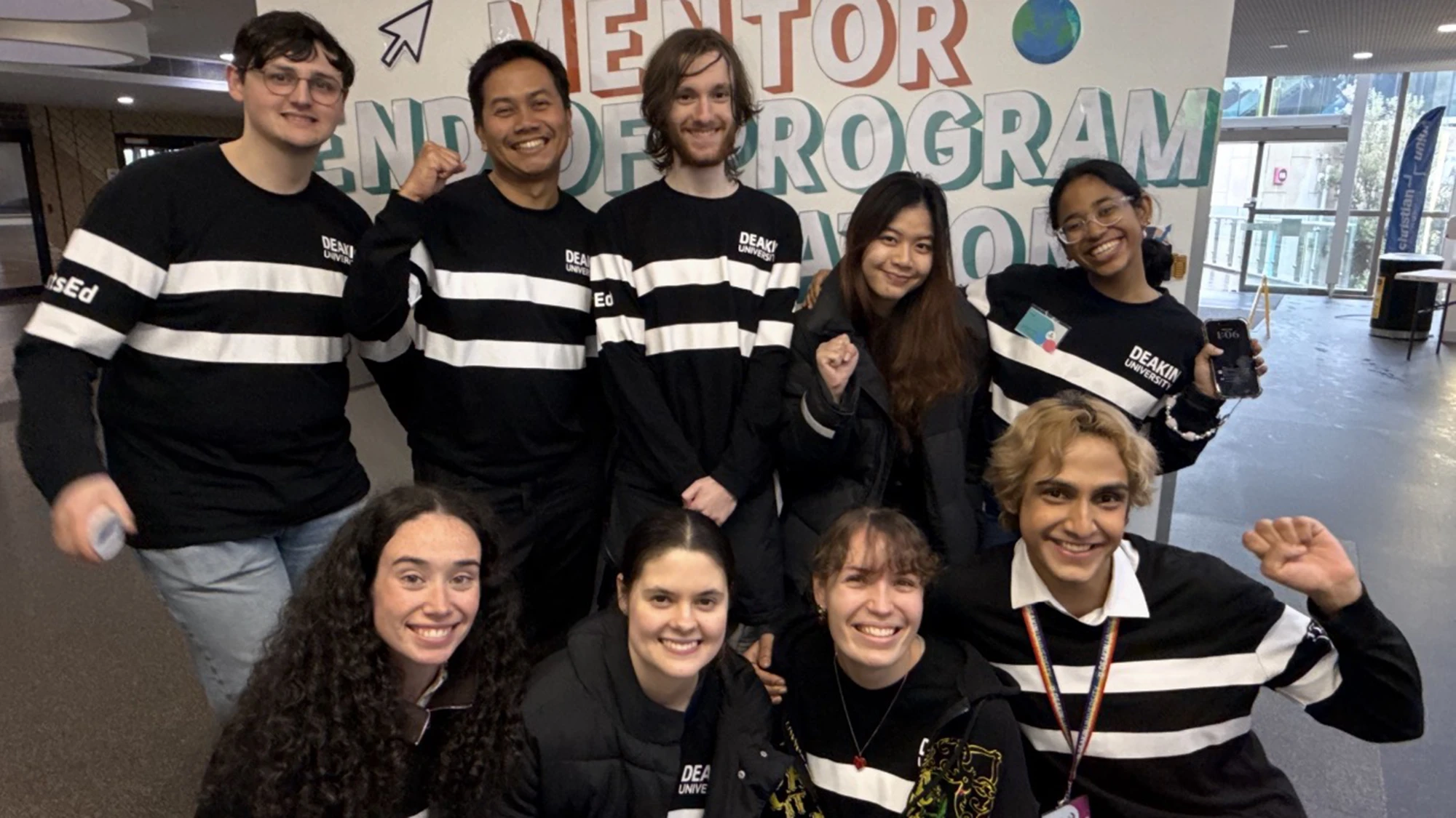 Gab and eight other peer mentors posing in a group, smiling
