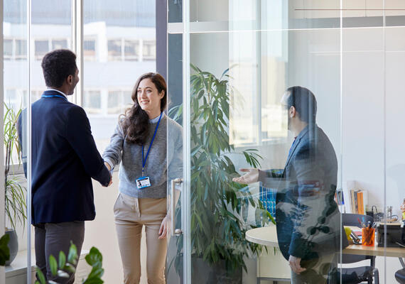Three colleagues chatting in an office