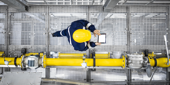 Looking down at engineer in industry plant.