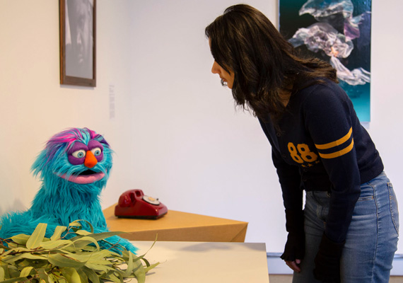 Person engages with a puppet.