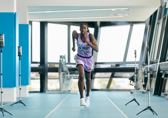Woman running in biomechanics laboratory.