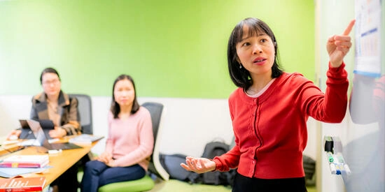 Research supervisor at front of classroom