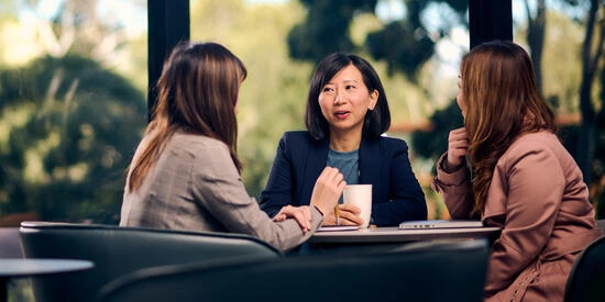 Three business students have a study meeting.