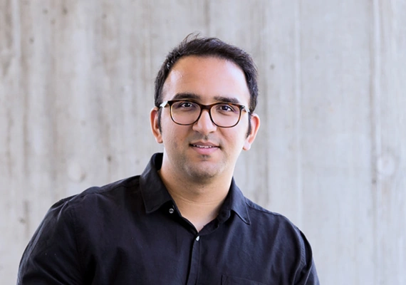 Deakin India student Vinay standing and smiling.