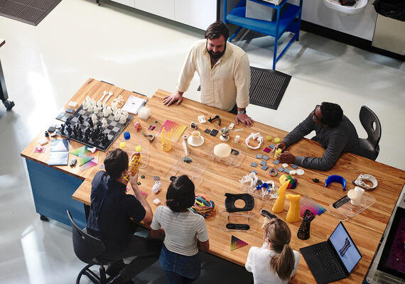 Students collaborating in the 3D printing lab