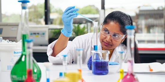 Deakin student scientist performing an experiment in a campus lab.
