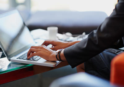Person typing on a laptop.