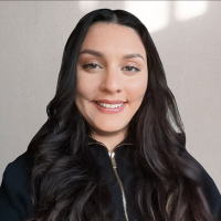 A headshot of Alex Galanti smiling at the camera.