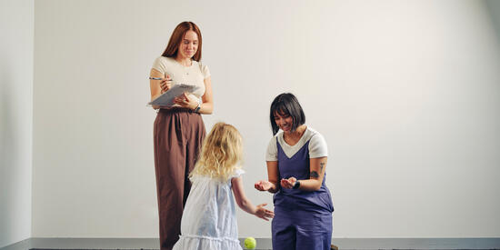 Two counsellors working with a small child. 