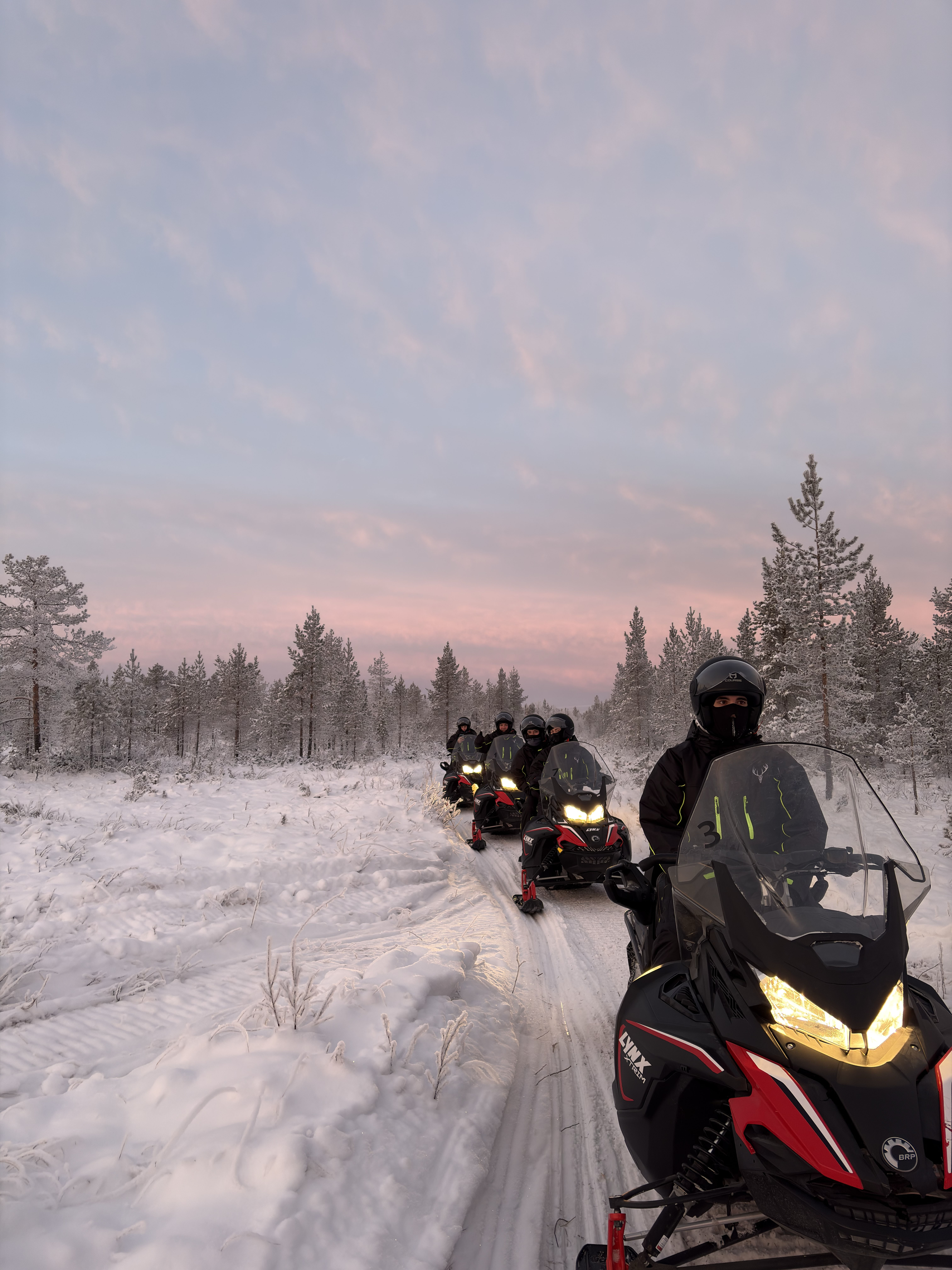 Josh and friends on snowmobiles in Lapland