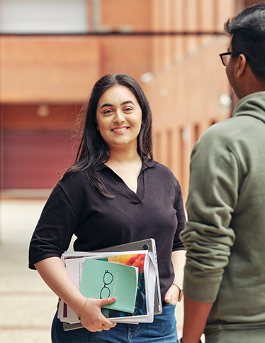 Two Deakin students socialise on the Burwood campus
