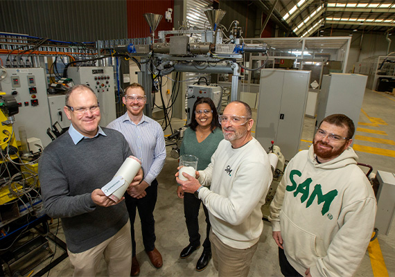 Deakin REACH and Samsara Eco research team at melt spinning machine with recycled plastic nylon sample